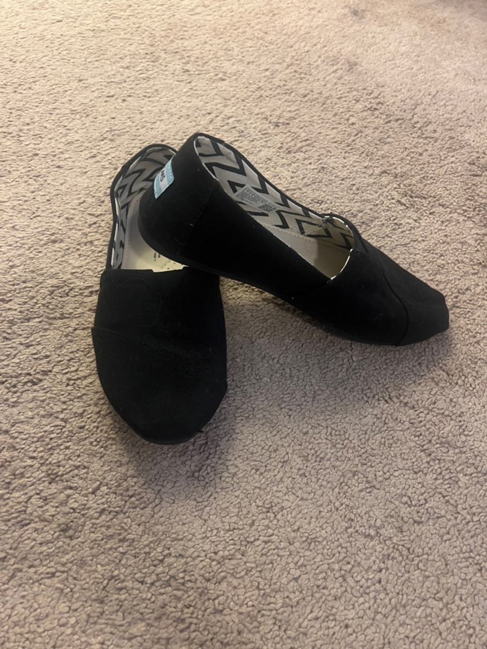 Black Women's Slip-On Flats - Classic Casual Comfort.  Tom’s black on black